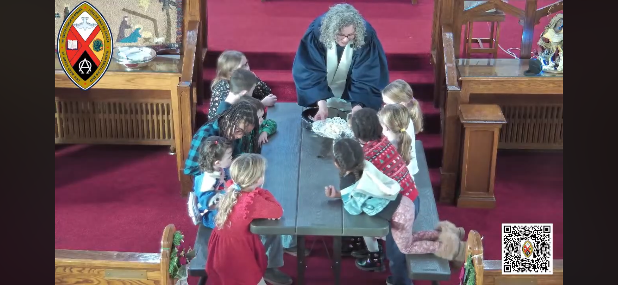 A gathering of children around a picnic table inside a church