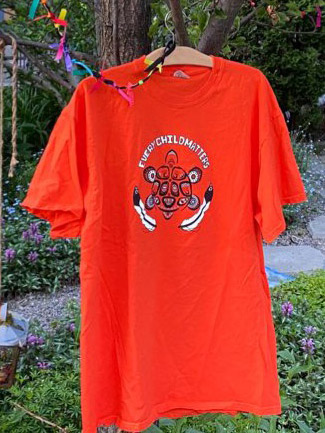 Orange shirt hanging in a tree