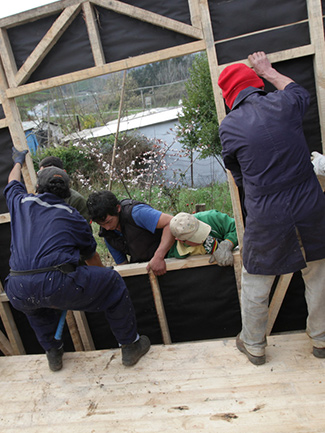 Volunteers building a home for earthquake victims.