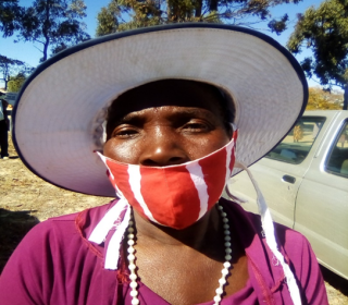 A woman in a hat and mask