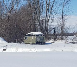 A photo of a trailer home in a snowy landscape.
