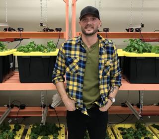 Jesse stands in the ydroponic greenhouse at Stella’s Circle.