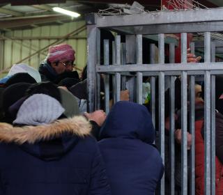 Palestinian crowds surge at the gate of the caged Qalandiya check point, Jerusalem.