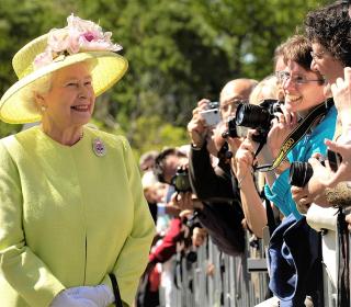 Queen Elizabeth greets onlookers at an event