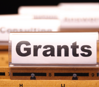 Closeup on the word Grants printed on the tab of a file folder