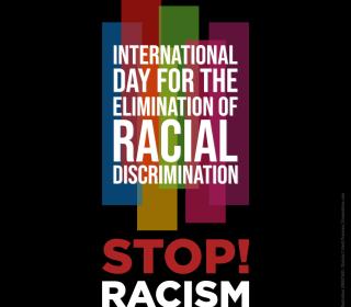 The words International Day for the Elimination of Racial Discrimination in white against 5 different-coloured vertical bars on a black square. The words Stop Racism! appear below the bars.