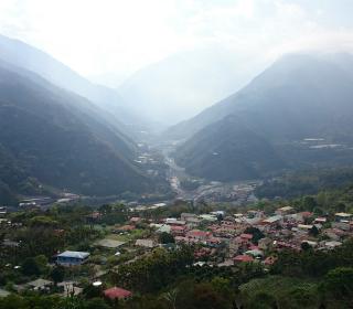 A small mountain village, with one main street, seen from an aerial view.