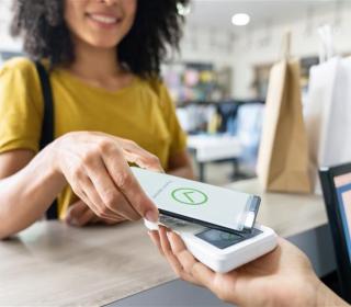 A woman makes a purchase using her phone