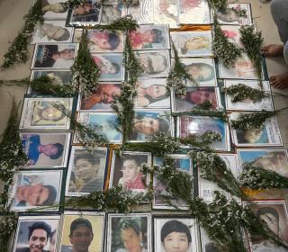 Several framed photos of Filipino youth surrounded by bouquets of flowers.