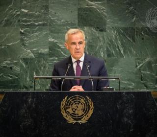 Prime Minister Mark Carney speaks at a podium at the United Nations