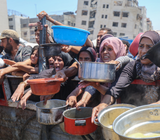 Palestinians gather for food aid