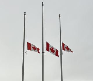 Three Canadian flags at half-mast
