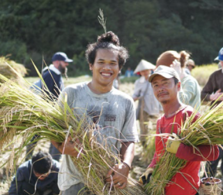 Participants with Asian Rural Institute harvest crops