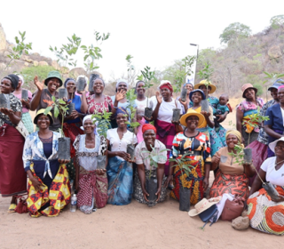 A group of smiling people outdoors in Zimbabwe