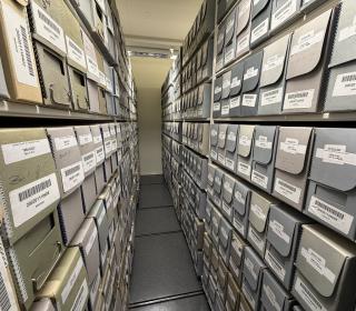 Rows of labelled archival boxes