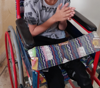 A boy in a wheelchair from the shoulders down