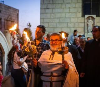 An easter procession outdoors attended by Palestinians