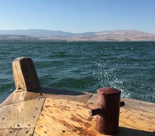 A picture of a wooden dock on the blue waters of the Sea of Galilee.