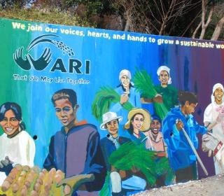 A colourful mural at the Asian Rural Institute depicting its motto “That we may live together.”