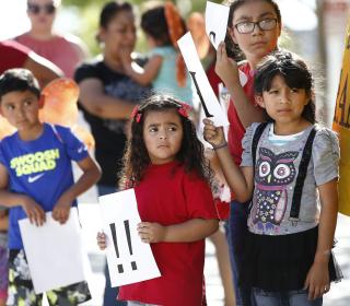 Children holding protest signs
