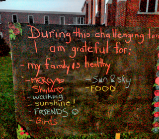 Outdoor blackboard inviting people to write what they're grateful for