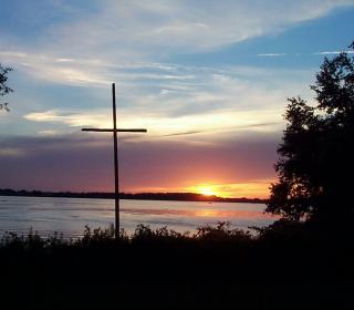 Cross at Scugog Lake Camp against sunset