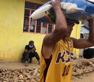 The Serve the People Brigade of the Cordillera Disaster Response Network distributes rice to people in need