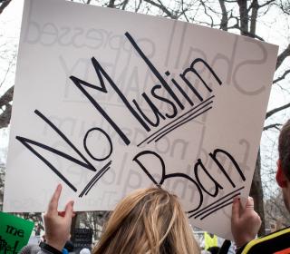 Sign being held aloft: No Muslim Ban