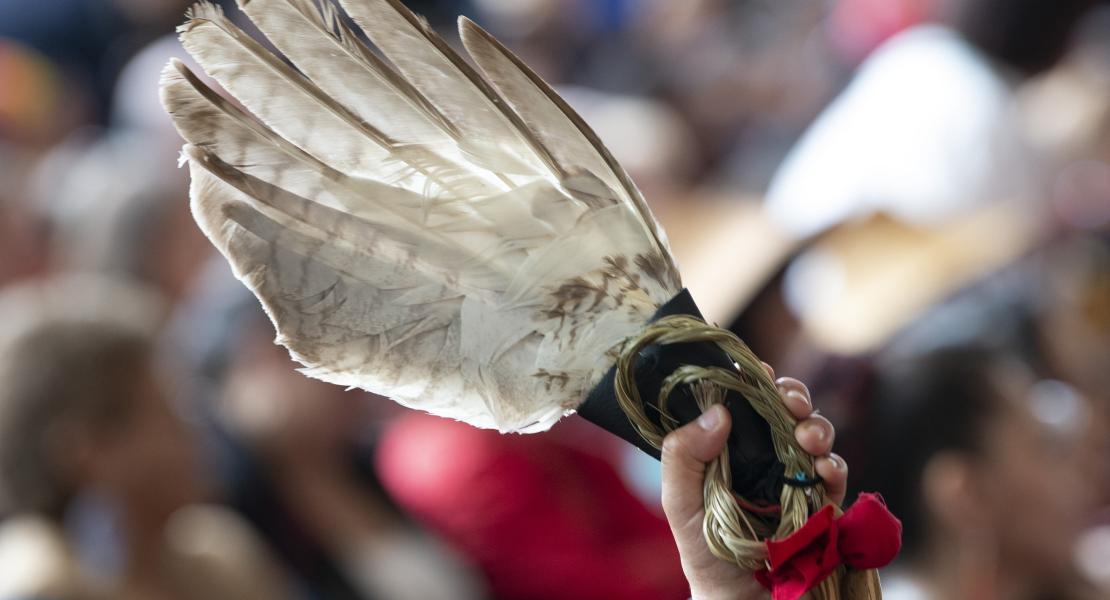 Photo of an eagle feather held up during ceremonies marking the release of the Missing and Murdered Indigenous Women report in Gatineau,  June 3, 2019