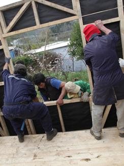 Volunteers building a home for earthquake victims.