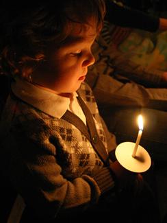 Boy holding a candle.