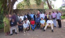 A large group of people gather for a photo in Kenya.