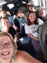 A group of young adults smile for a selfie photo on a bus in Palestine Israel.