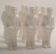 An installation of nine replicas of a rotund Black man in a hoodie.