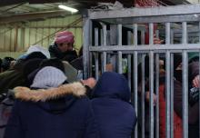 Palestinian crowds surge at the gate of the caged Qalandiya check point, Jerusalem.