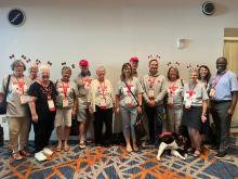 A group of individuals in a boardroom, many wearing Canadian flag headbands.