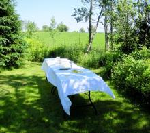 A table set up for a casual worship service on a grassy lawn.