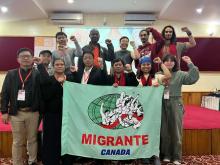 A group of people with fists raised and a sign that reads "Migrante Canada"