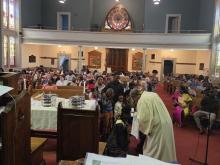 A group of children being baptised in a church