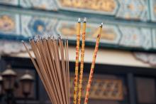 Numerous sticks of incense burn in front at a temple in Hong Kong.