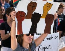 White allies holding signs supporting racial justice a march in Washington, D.C., Sept. 2017.