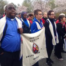 The author Paul Douglas Walfall (left) marches with the members of the United Church of Canada Delegation to the ACT March to End Racism carry a United Church banner at the event.