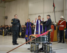 Military chaplains from several different denominations consecrate the guidon of the Saskatchewan Dragoons in a ceremony.