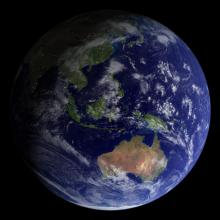 A photo of a nearly full Earth as seen from space. The land masses of Australia and India can be seen, amidst a lot of deep blue ocean and white clouds.