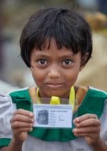 A Rohingya girl, having just crossed the border from Myanmar, shows her new identity card that she was given by United Nations workers in a refugee camp in Bangladesh.