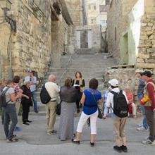 People standing in front of old buildings