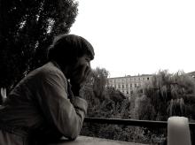 A white person sitting in thoughtfulness.