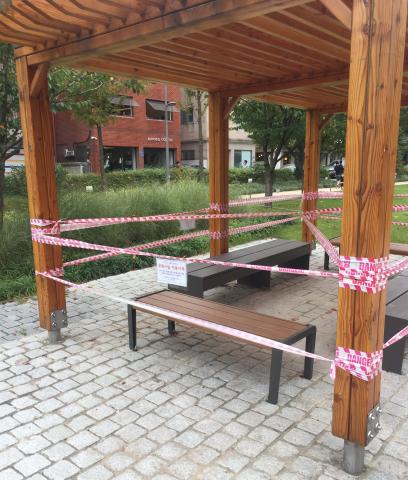 A wooden pavilion in Seoul, Korea is taped off and restricted from use during the COVID-19 pandemic.