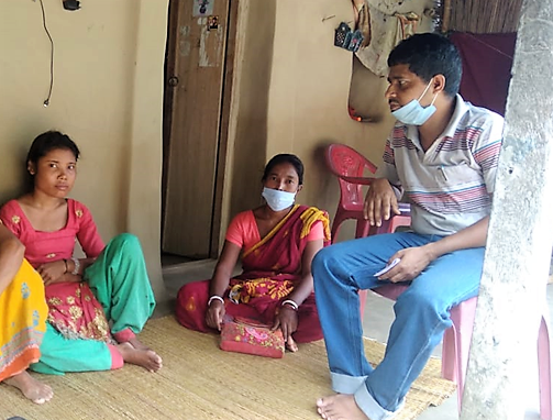 Lakshmi with her parents on porch, India