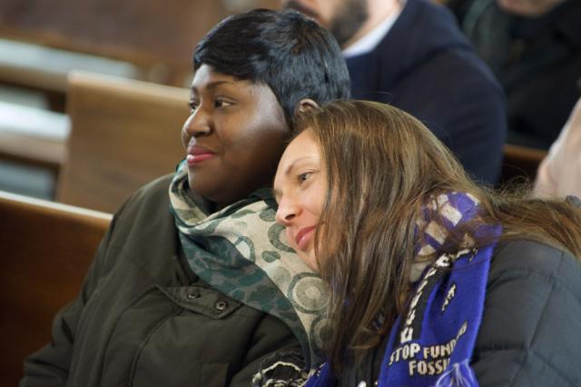 Two women sitting in a church pew.